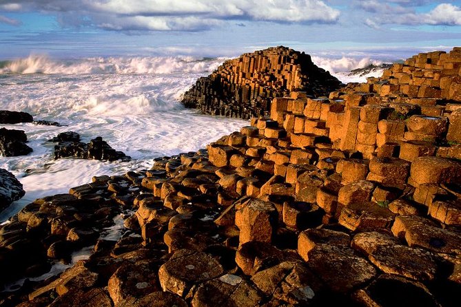 Giant's Causeway and more including Titanic Experience Ticket Tour from Belfast - Dunluce Castle: a dramatic glimpse from the road