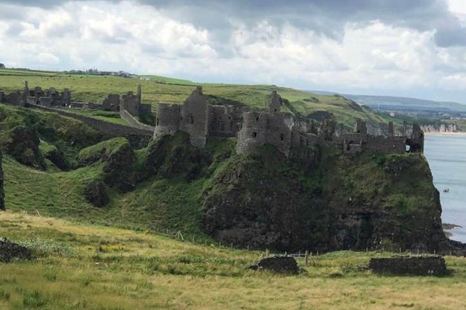 Private Giants Causeway & Antrim Coast Tour - Dunluce Castle above the sea